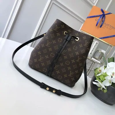 Brown monogram bucket bag with a drawstring top and black strap