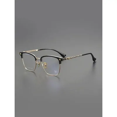Browline glasses with gold wire rims on a grey backdrop