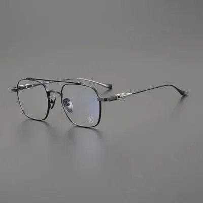 Square titanium-frame glasses on a grey backdrop